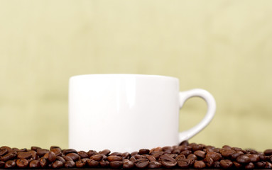 white coffee cup and coffee beans