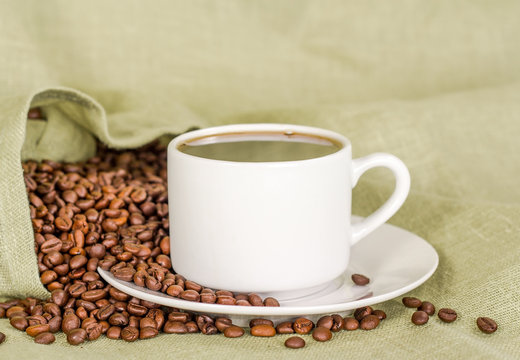 white coffee cup and coffee beans