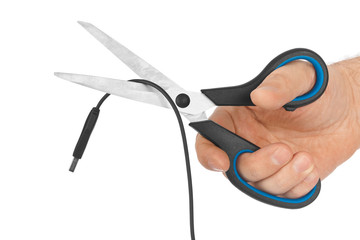 Hand with scissors and computer cable