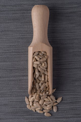 Wooden scoop with shelled sunflower seeds