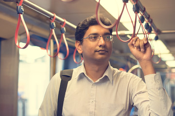 indian business male taking subway to work