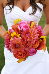 Bride Holding Wedding Bouquet with Orange and Pink Flowers