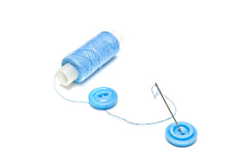 spool of blue thread and blue buttons