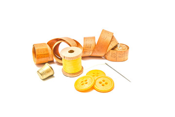 thimble, buttons and spool of yellow thread