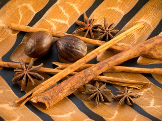 Cinnamon, star anise and nutmeg on the wooden background
