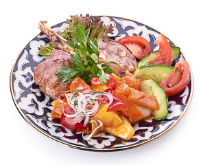 Meat on a grill with vegetables
