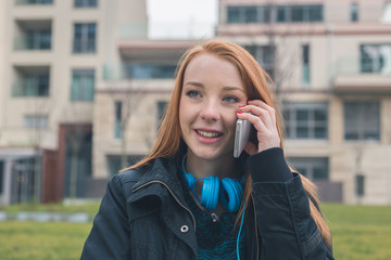 Beautiful girl talking on phone in an urban context