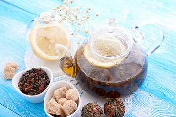 drink in glass teapot on wooden background