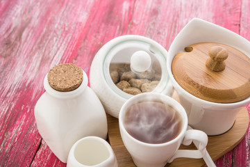 tea with sugar cubes on wooden