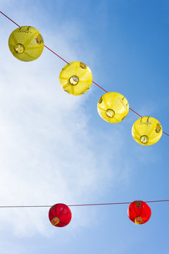 Red and yellow Chinese lanterns with blue sky in the background
