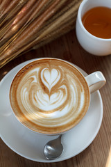 Cup of latte coffee with tea