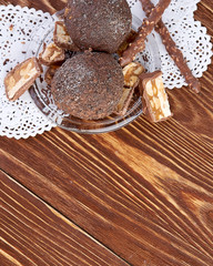 Cupcake with chocolate on wooden background