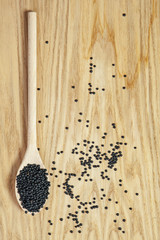 Black lentils and wooden spoon