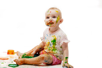 Baby soiled by paint lodges on a light background