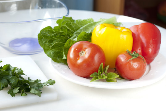 raw vegetables for salad on white plate