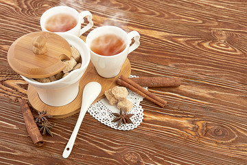 tea with sugar cubes on wooden