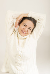 Fototapeta premium Beautiful woman in warm clothing on white background smiling
