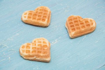 three waffles on a blue background