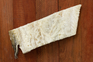 salted cod fish on brown wooden background