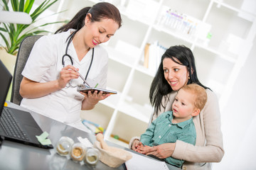 Young woman and her child at the doctor homeopaths. 