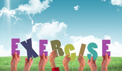 Composite image of hands holding up exercise