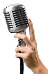 Audience. Female hand holding a single retro microphone against