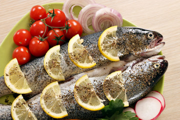 prepared trout fish with lemon and vegetables