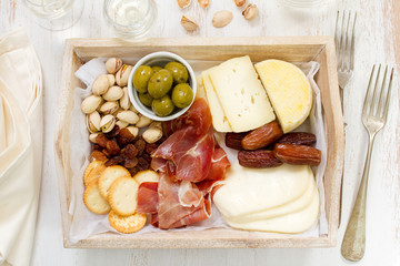 cheese with prosciutto, cookies, olives and wine