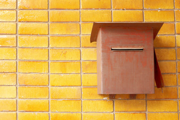 Closeup photo of a Vintage postbox on brick wall