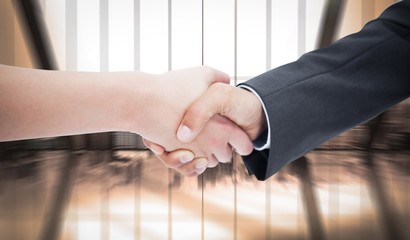 Composite image of close up of a handshake