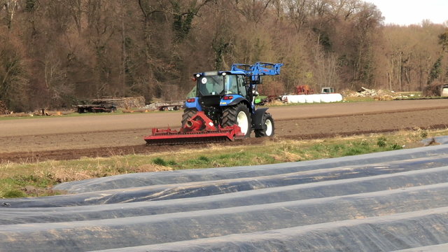 Farm tractor on a field in spring