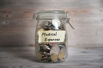 Money jar with medical expenses label.