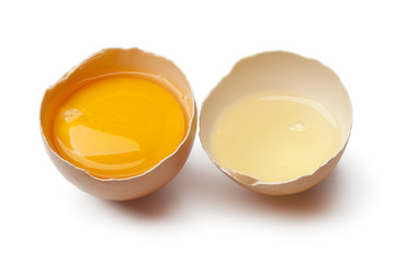 Egg yolk and white in a broken egg shell