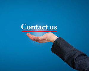 Businessman hand holding business card with contact us text