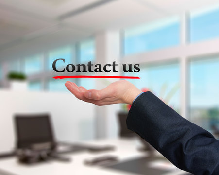 Businessman hand holding business card with contact us text