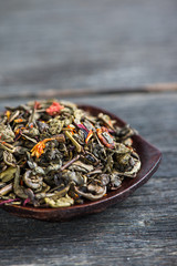 Aromatic antioxidant green tea on wooden board