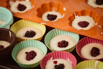 Rows of colorful cups. Muffins preparation at home.