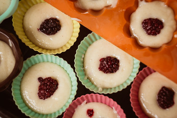 Rows of colorful cups. Muffins preparation at home.