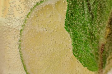 Mojito cocktail with fresh lime on wood table