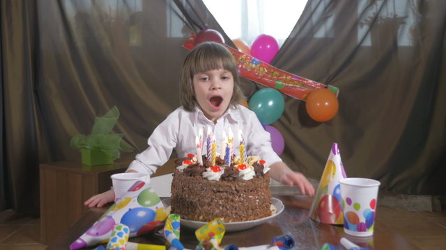Girl blowing candles on a birthday cake 