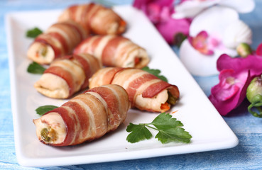 Chicken rolls stuffed with vegetables wrapped in bacon