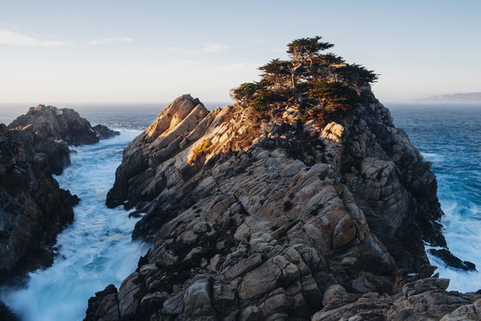 Dramatic cliffs and coastline at dusk in the Point Lobos State Reserve on the Pacific coastline. White foaming water. 