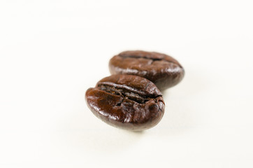 close up of roasted coffee beans isolated on white background