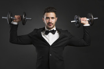 Obraz na płótnie Canvas Young man lifting weights