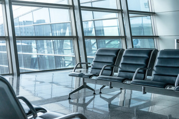 airport waiting area , seats and outside the window scene