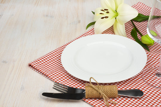 Served restaurant table with settings on red tablecloth