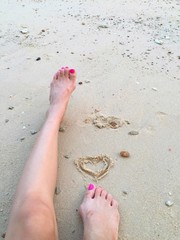 drawing heart on beach. 