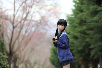 Naklejka na ściany i meble asian schoolgirl with nature