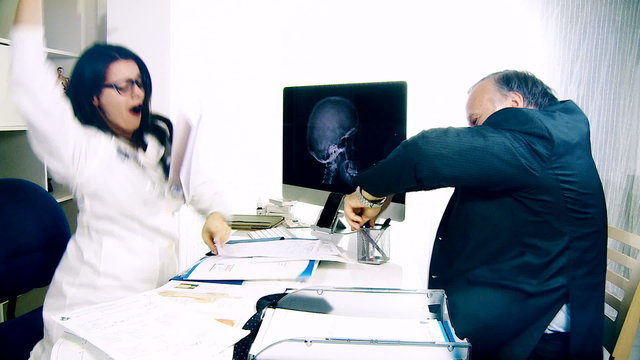 woman doctor and man dancing in office happy