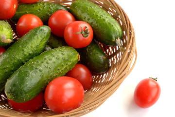 cucumbers and tomatoes in a wicker basket